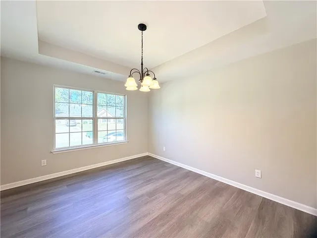 a kitchen with granite countertop a refrigerator stove and microwave