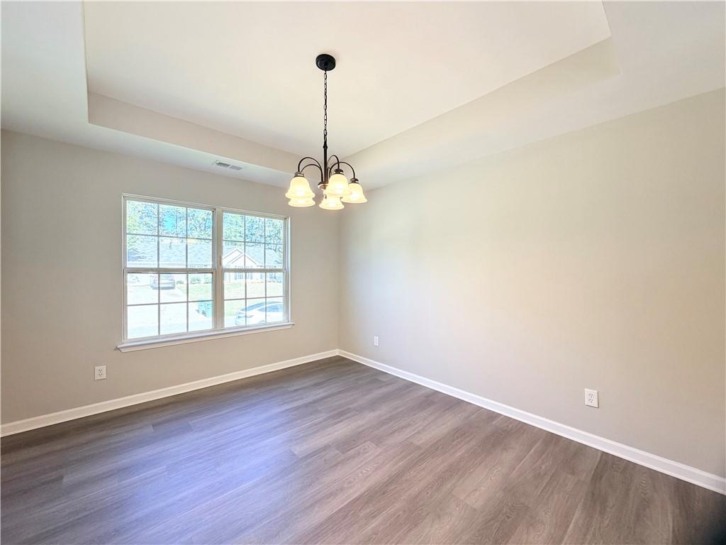 382 Arlington Lane Commerce, GA 30529 - Photo 8 of 43 a view of an empty room with window and wooden floor