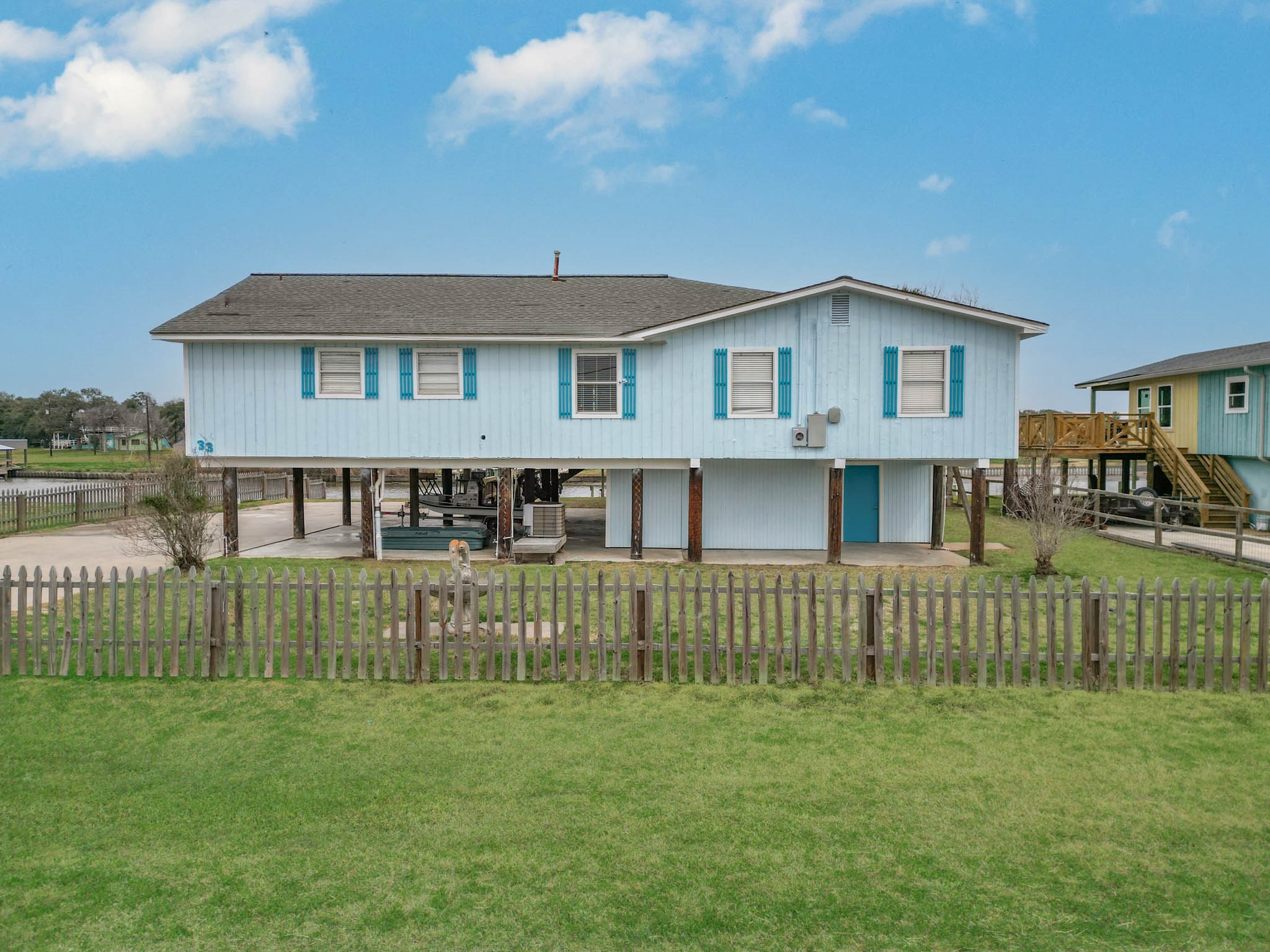 a front view of a house with a garden and yard
