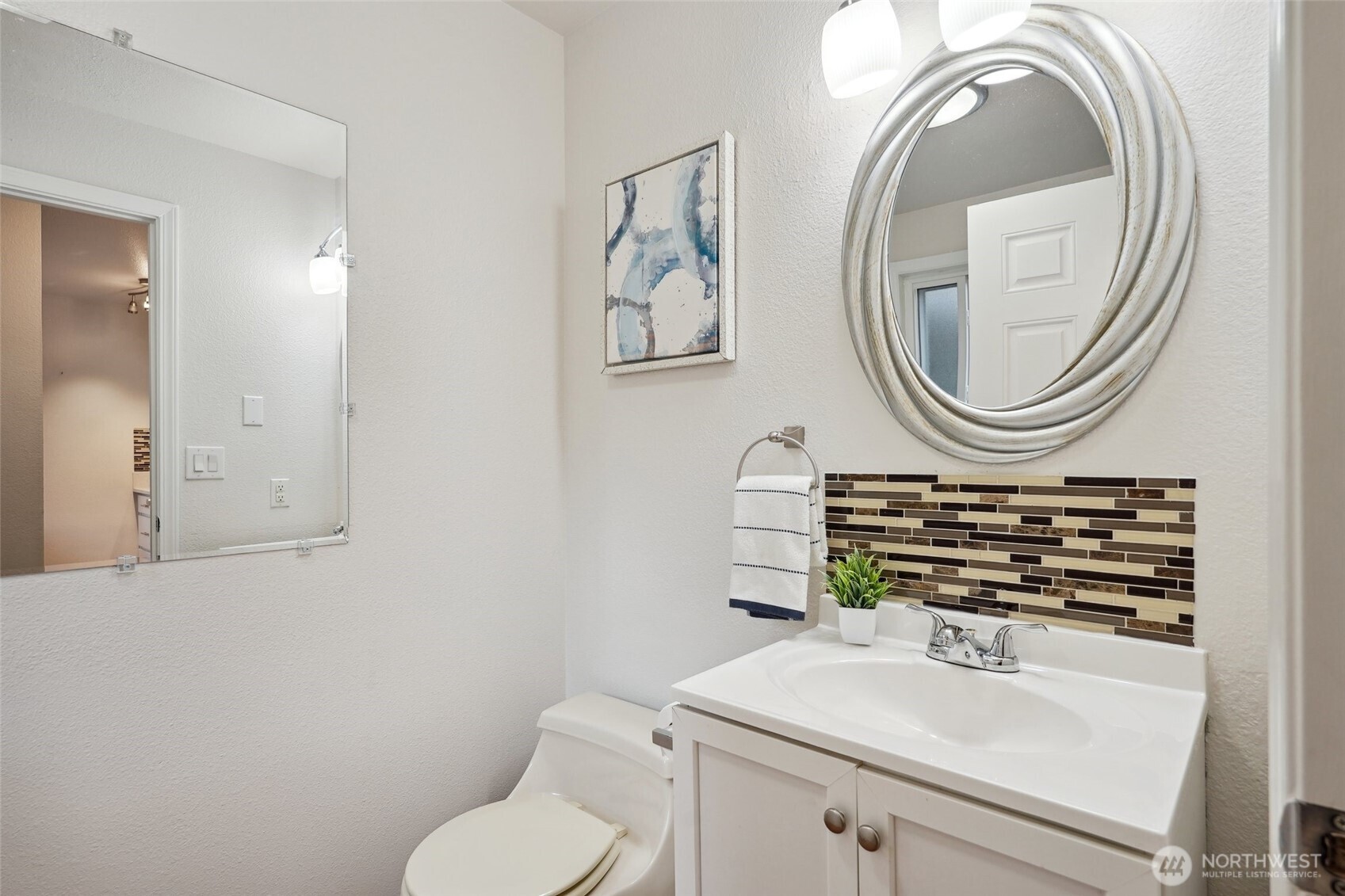 18910 Bothell Everett Highway, Unit K2 Bothell, WA 98012 - Photo 14 of 34 a bathroom with a toilet a sink and a mirror