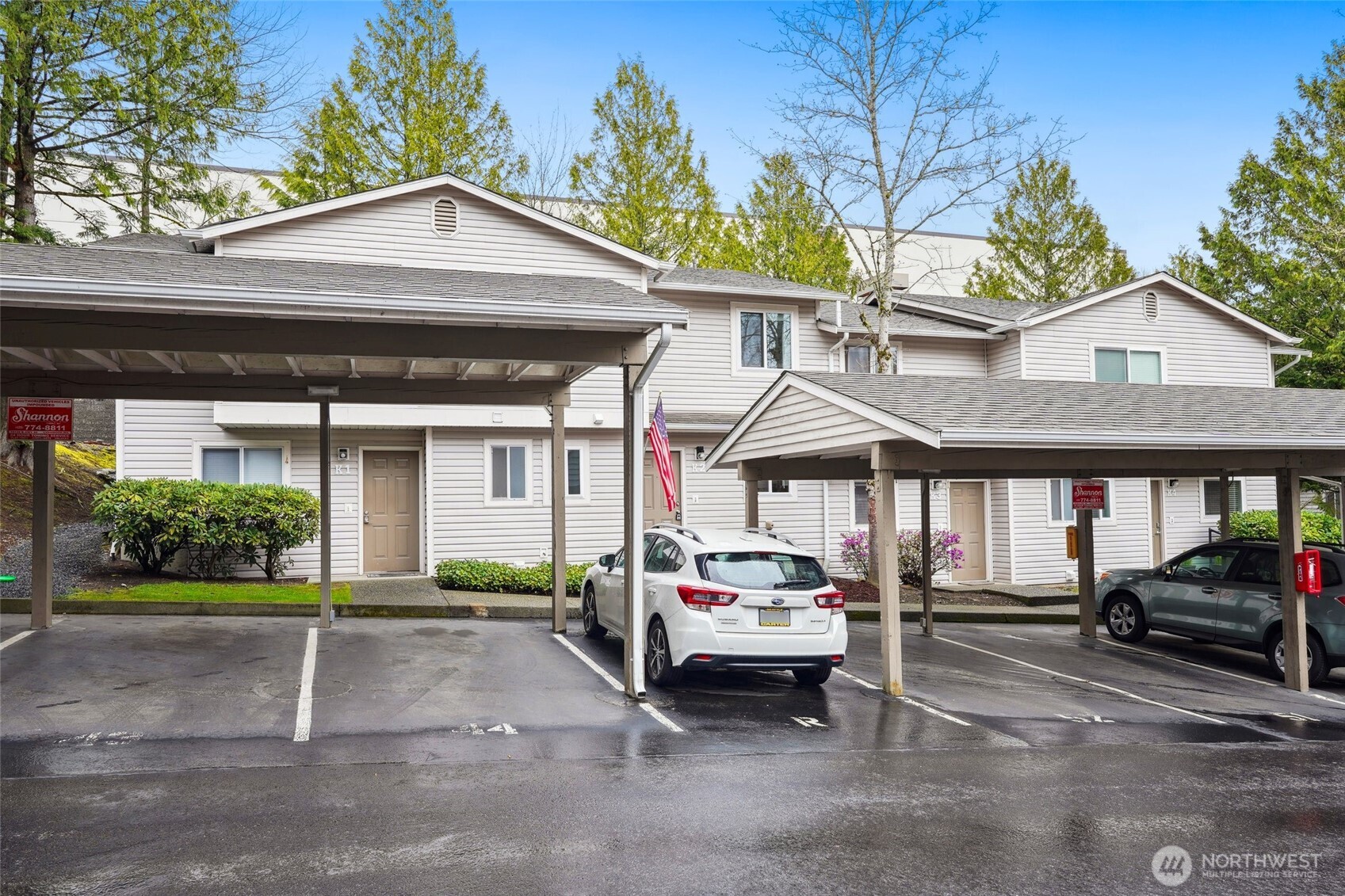 18910 Bothell Everett Highway, Unit K2 Bothell, WA 98012 - Photo 24 of 34 a car parked in front of a white house