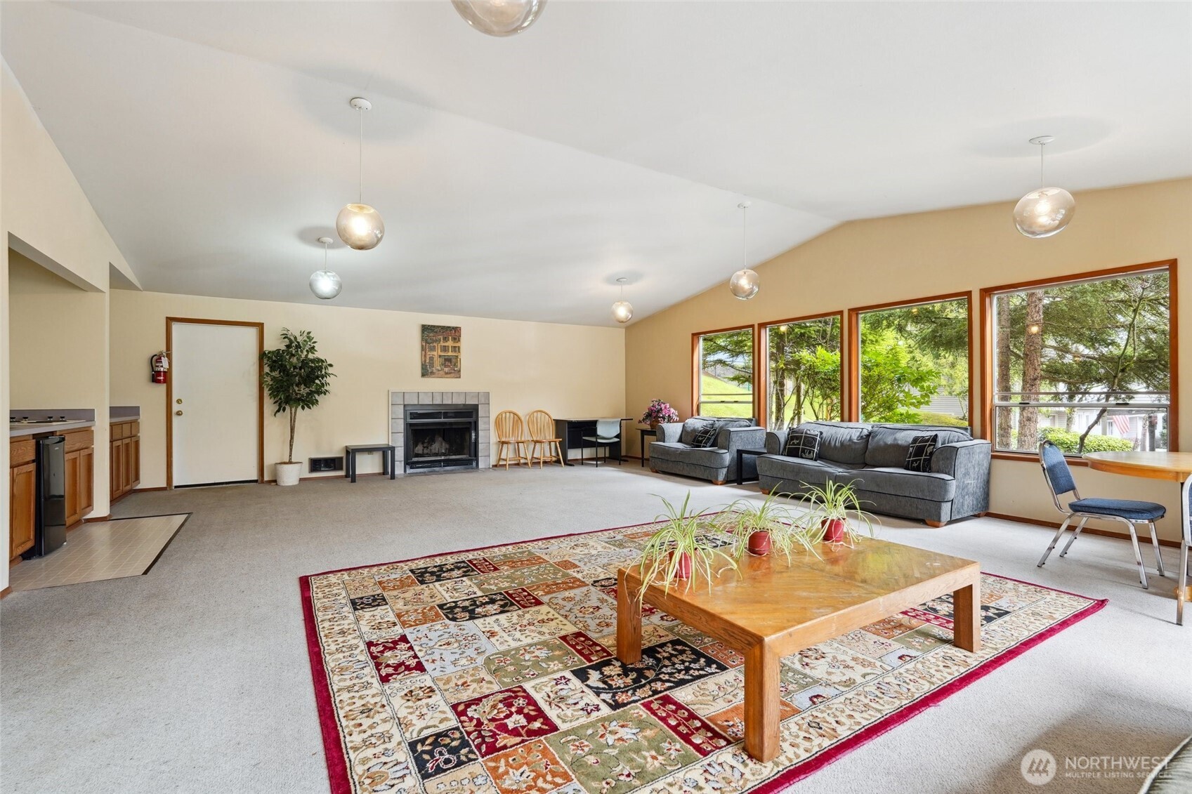 18910 Bothell Everett Highway, Unit K2 Bothell, WA 98012 - Photo 33 of 34 a living room with furniture a window and a table