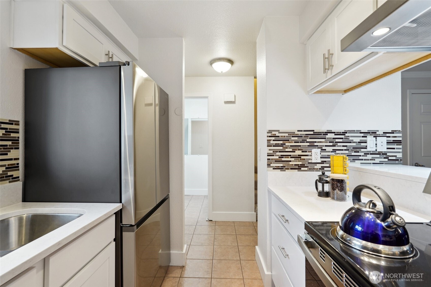 18910 Bothell Everett Highway, Unit K2 Bothell, WA 98012 - Photo 4 of 34 a kitchen with a refrigerator and a stove