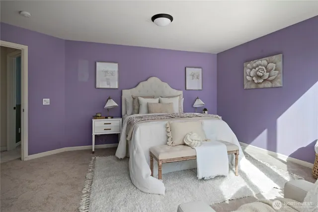 a bedroom with a bed and a potted plant