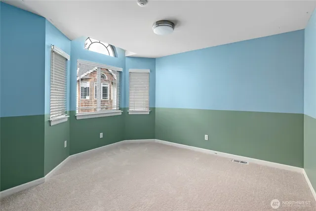 a view of a room that has a fan and window in it