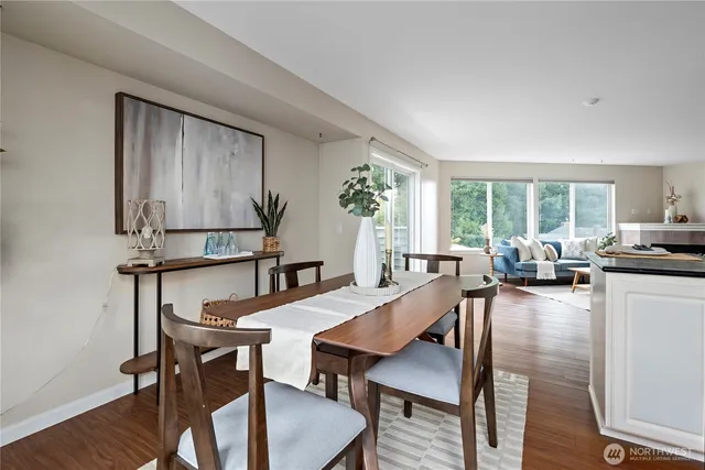 a view of a dining room with furniture window and wooden floor