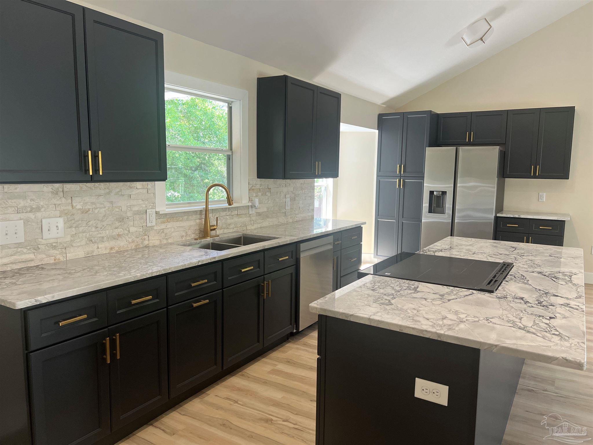 3111 Holley Point Road Navarre, FL 32566 - Photo 4 of 23 a kitchen with a sink and a refrigerator