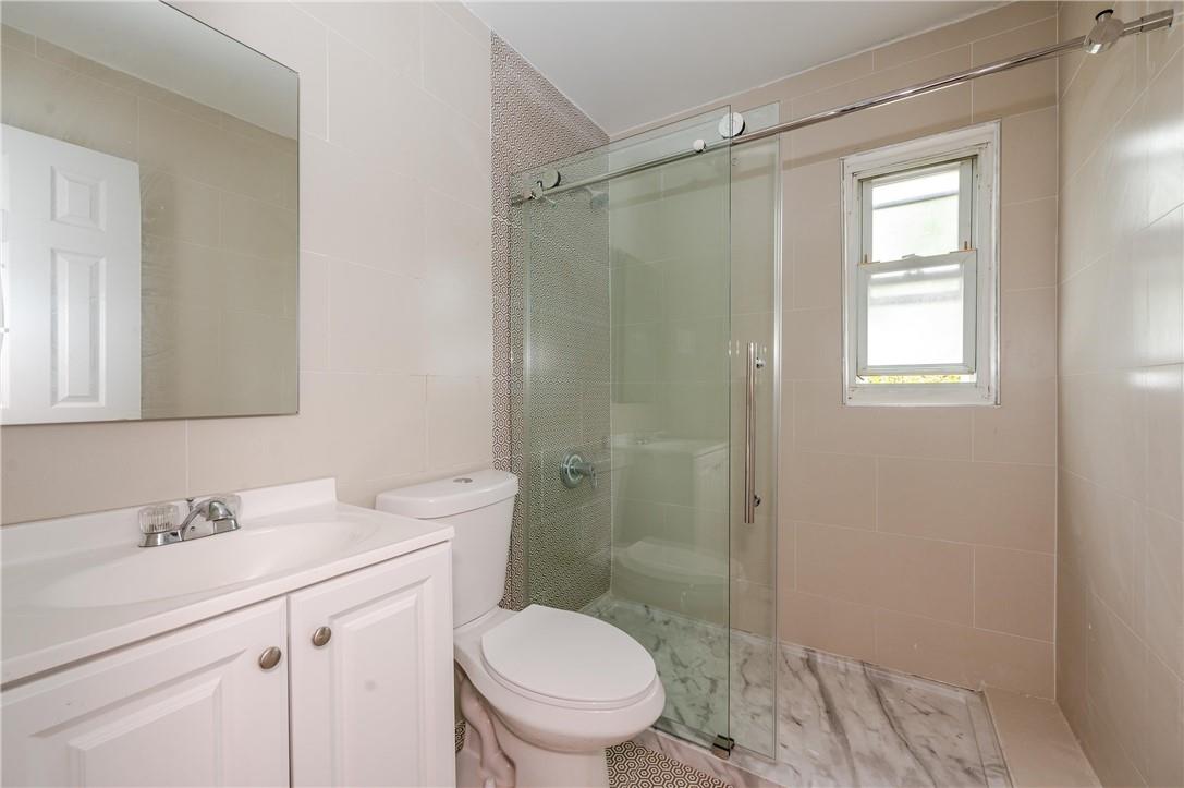2855 Middletown Road Bronx, NY 10461 - Photo 13 of 19 a bathroom with a shower sink vanity mirror and toilet