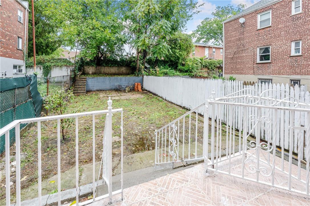 2855 Middletown Road Bronx, NY 10461 - Photo 14 of 19 a view of a house with a small yard and wooden fence
