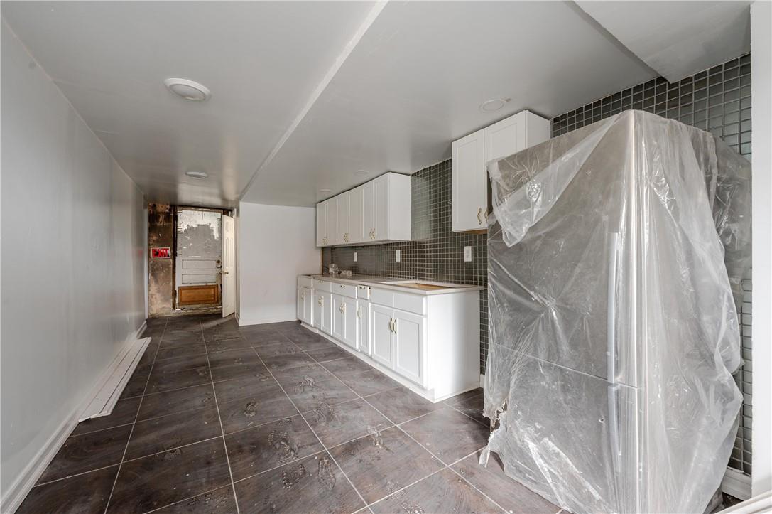 2855 Middletown Road Bronx, NY 10461 - Photo 17 of 19 a kitchen with cabinets and a stove top oven