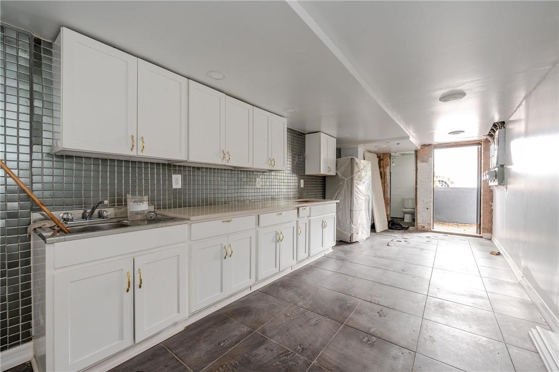 2855 Middletown Road Bronx, NY 10461 - Photo 18 of 19 a large white kitchen with granite countertop a sink