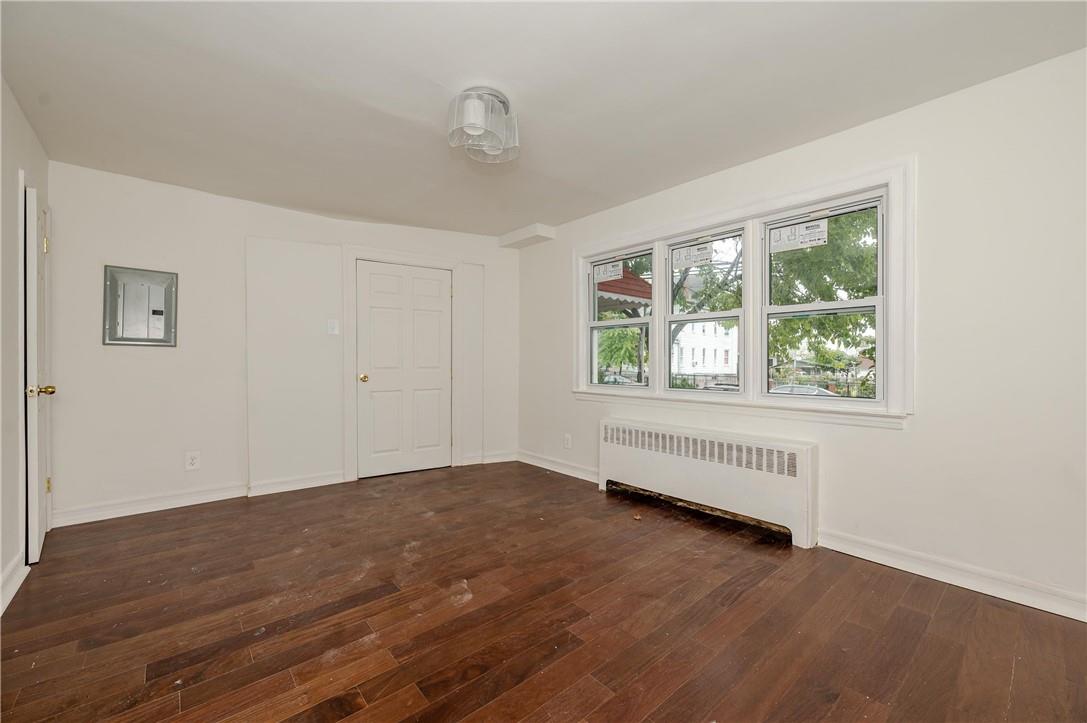 2855 Middletown Road Bronx, NY 10461 - Photo 3 of 19 wooden floor in an empty room with a window