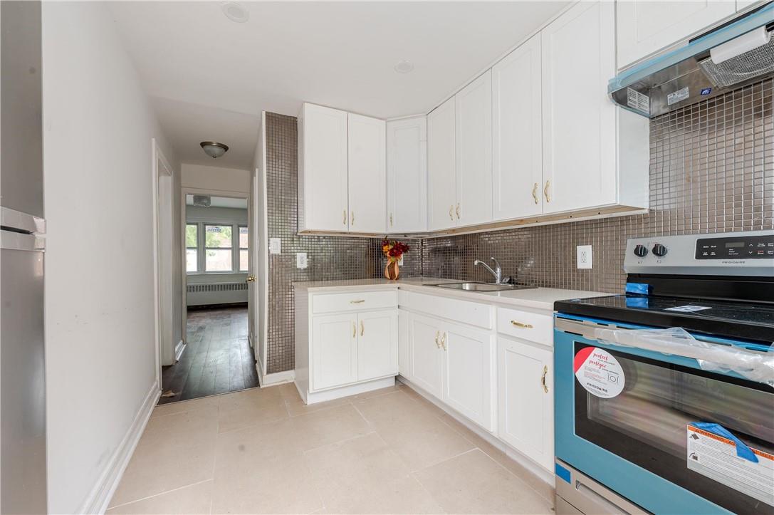 2855 Middletown Road Bronx, NY 10461 - Photo 5 of 19 a kitchen with granite countertop a sink and a stove
