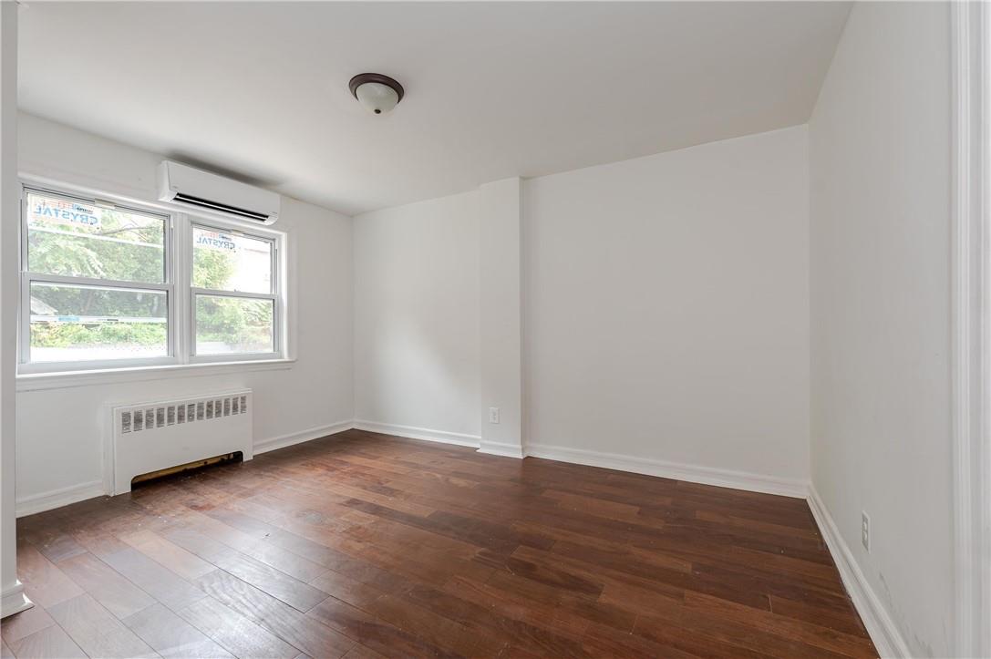 2855 Middletown Road Bronx, NY 10461 - Photo 7 of 19 an empty room with wooden floor and windows