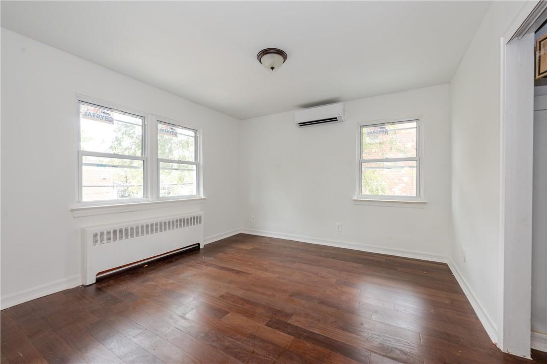 2855 Middletown Road Bronx, NY 10461 - Photo 8 of 19 an empty room with wooden floor and windows