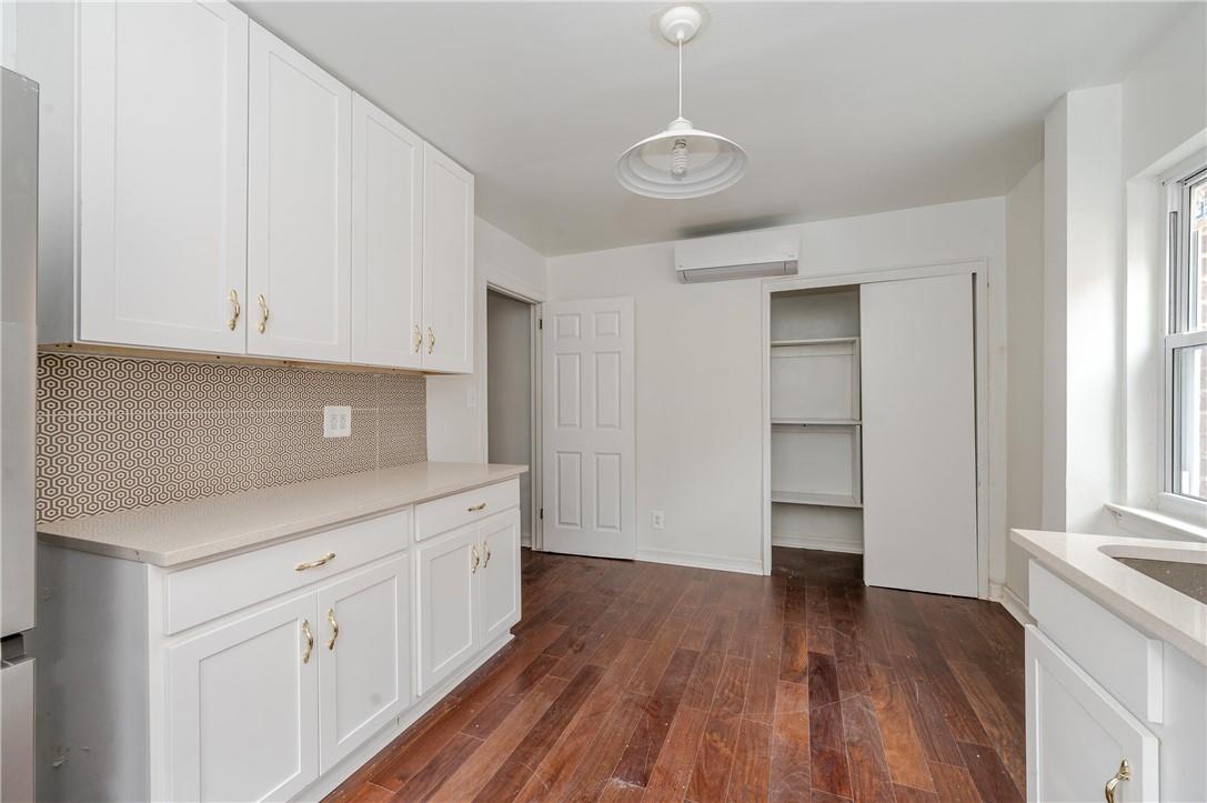 2855 Middletown Road Bronx, NY 10461 - Photo 10 of 19 a kitchen with white cabinets and wooden floor