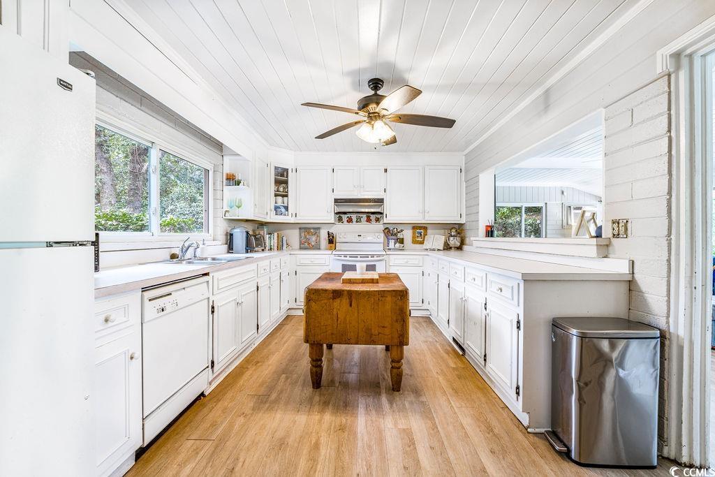 910 Willow Bank Road Georgetown, SC 29440 - Photo 20 of 40 Kitchen with white cabinetry, white appliances, wood ceiling, light countertops, and light wood-style floors