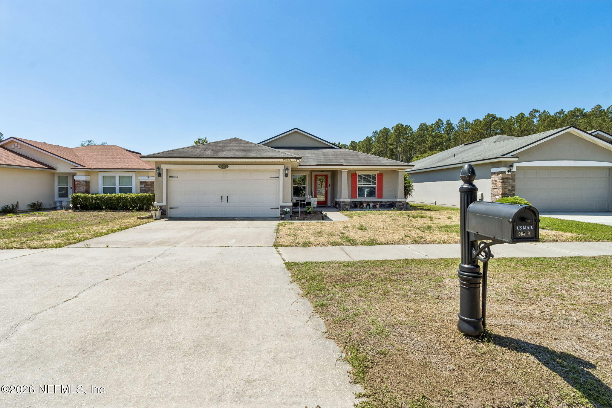 96034 Bass Lane Yulee, FL 32097 - Photo 4 of 50 a front view of a house with a yard