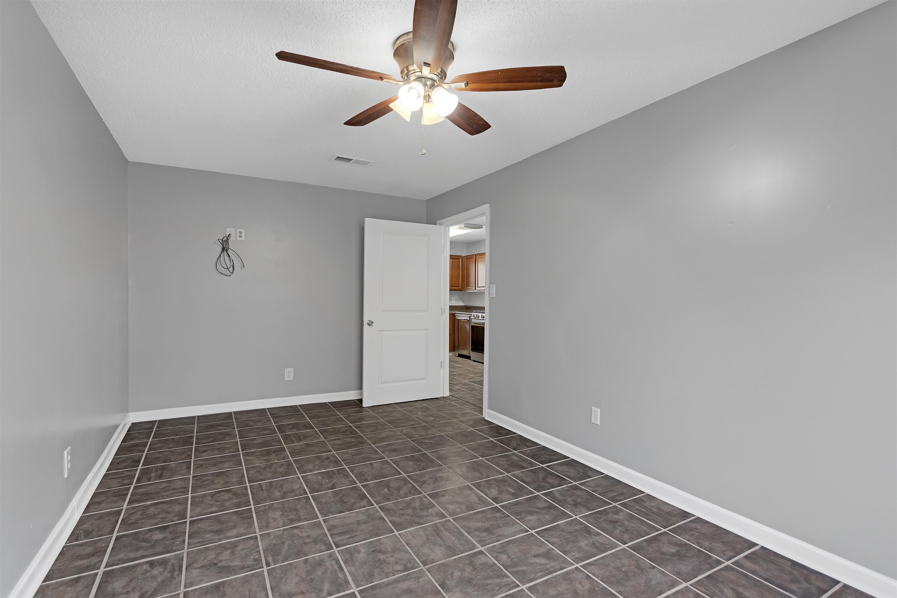 3324 William Tell Drive Memphis, TN 38127 - Photo 15 of 28 Unfurnished room with ceiling fan and dark tile patterned floors