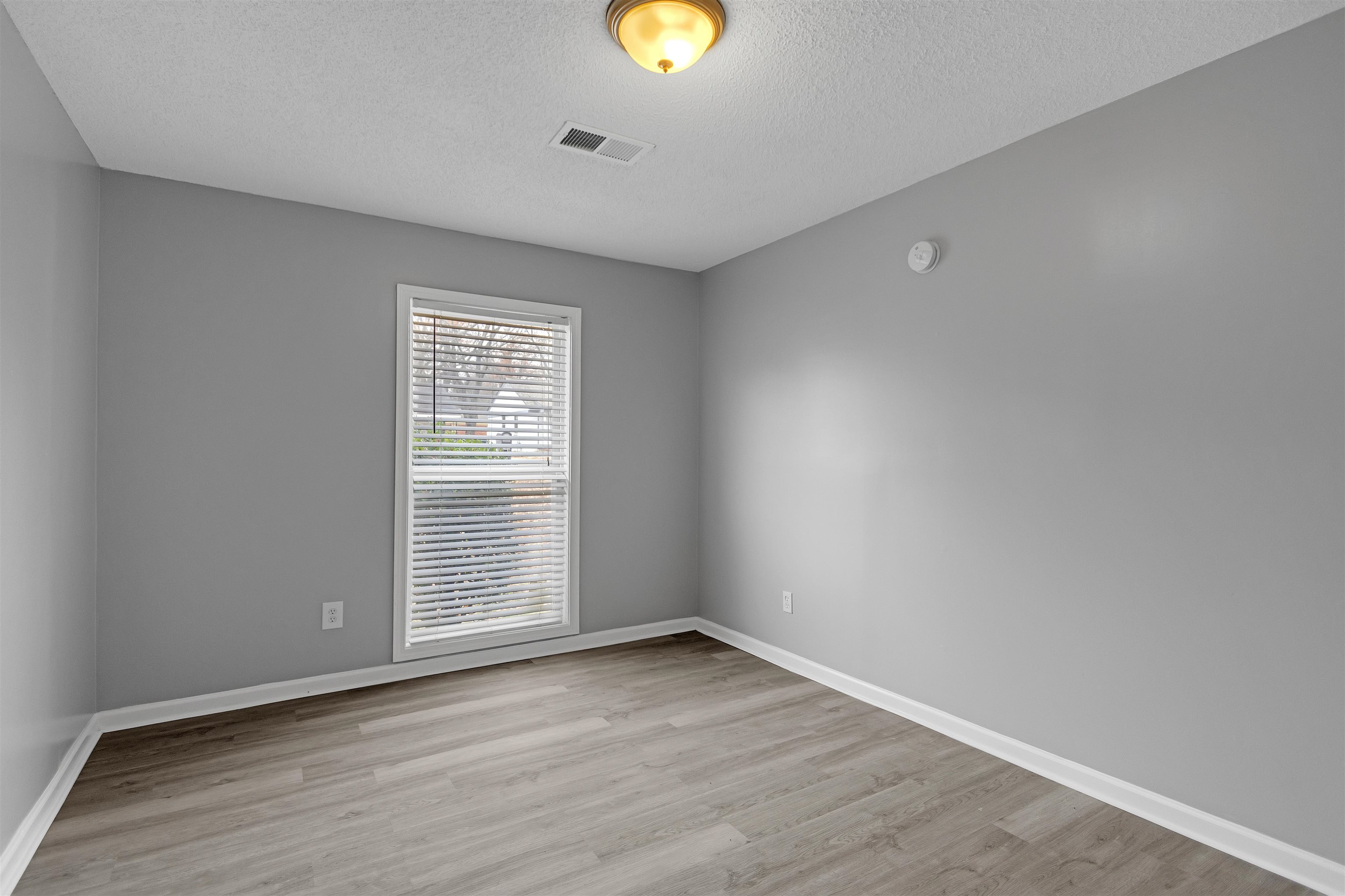 3324 William Tell Drive Memphis, TN 38127 - Photo 17 of 28 Unfurnished room featuring a textured ceiling and light hardwood / wood-style flooring