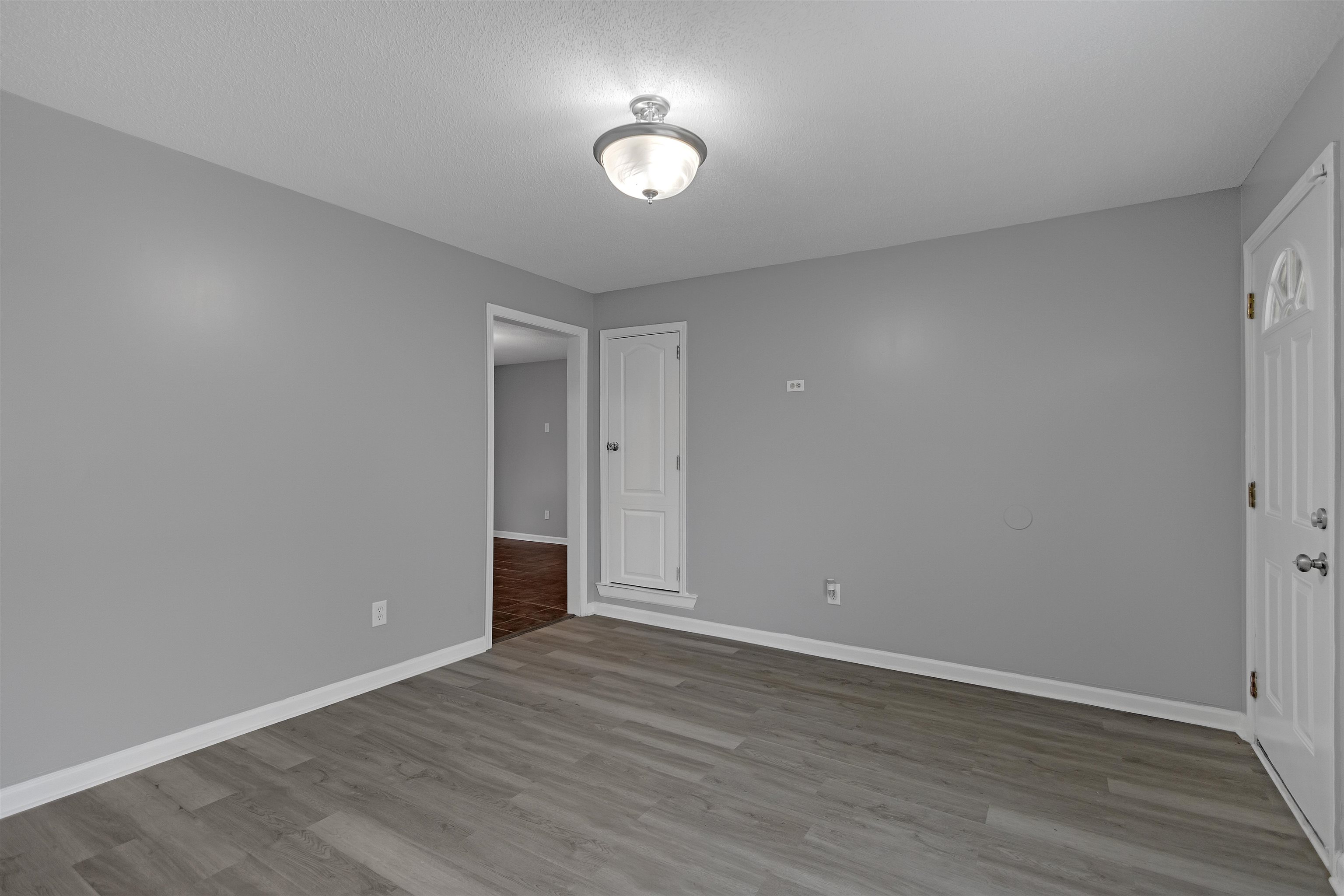 3324 William Tell Drive Memphis, TN 38127 - Photo 6 of 28 Empty room featuring a textured ceiling and hardwood / wood-style flooring