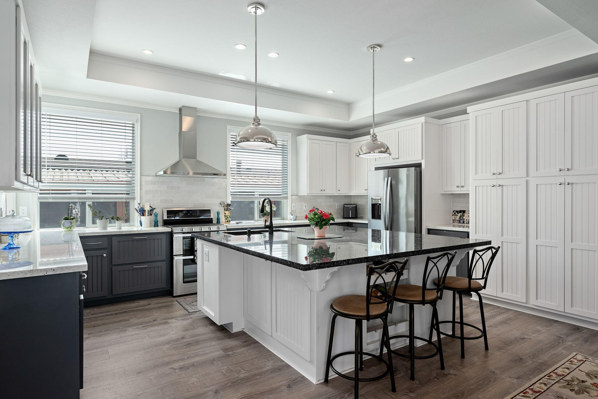 340 Old Mill Road, Unit 237 Santa Barbara, CA 93110 - Photo 12 of 30 a kitchen with stainless steel appliances granite countertop a stove a sink dishwasher a refrigerator and a dining table with wooden floor