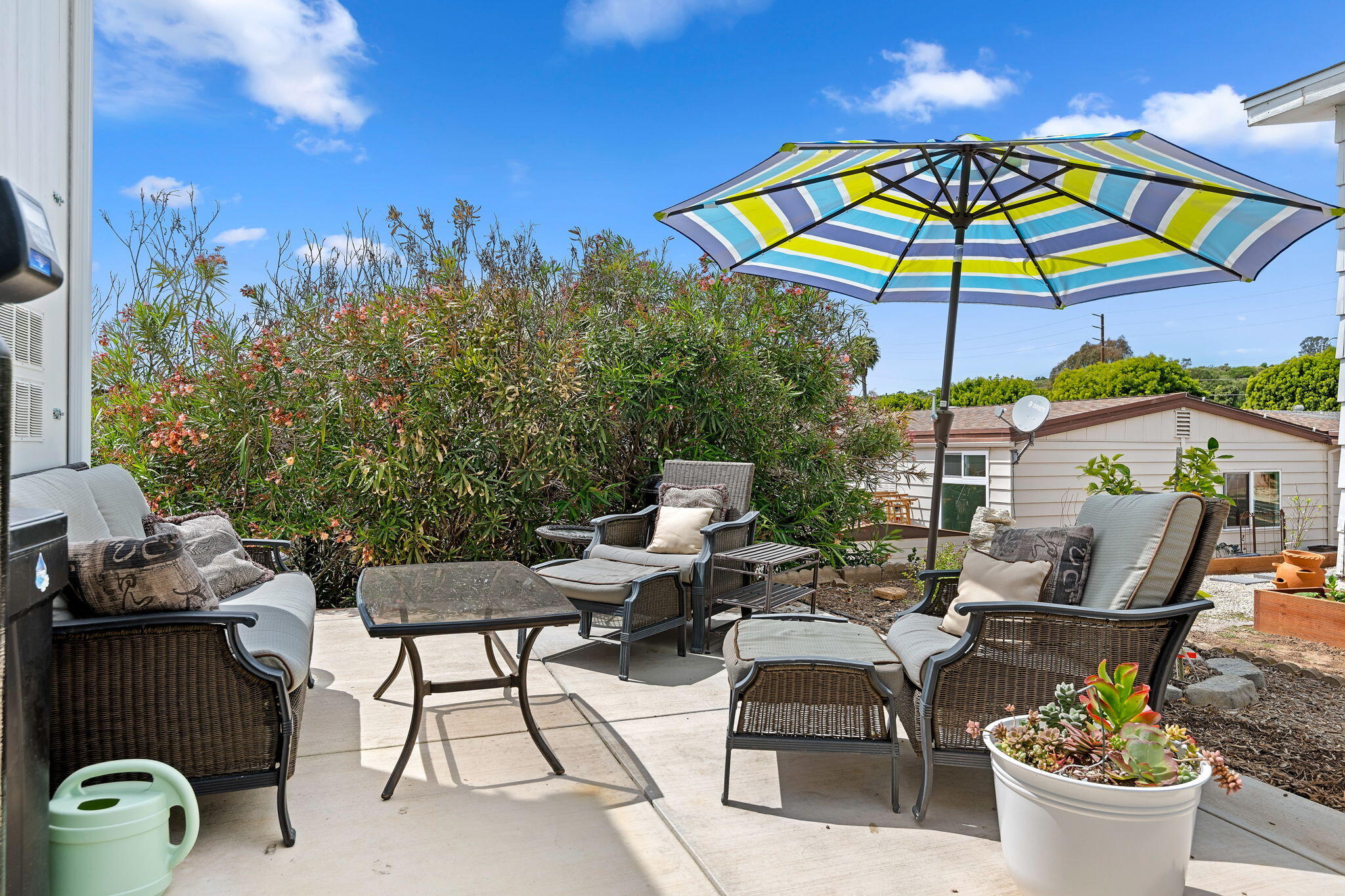 340 Old Mill Road, Unit 237 Santa Barbara, CA 93110 - Photo 24 of 30 a view of a patio with chairs and table under an umbrella
