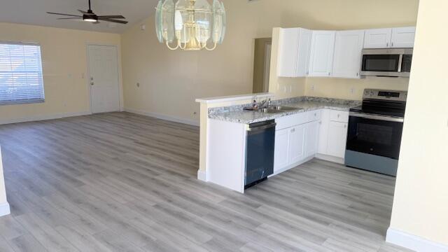 4262 Southwest Jared Street Port St. Lucie, FL 34953 - Photo 11 of 29 a kitchen with a sink wooden floor and a stove top oven