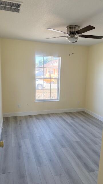 4262 Southwest Jared Street Port St. Lucie, FL 34953 - Photo 14 of 29 wooden floor in an empty room with a window