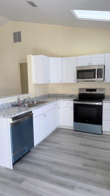 4262 Southwest Jared Street Port St. Lucie, FL 34953 - Photo 8 of 29 a kitchen with granite countertop a stove and cabinets