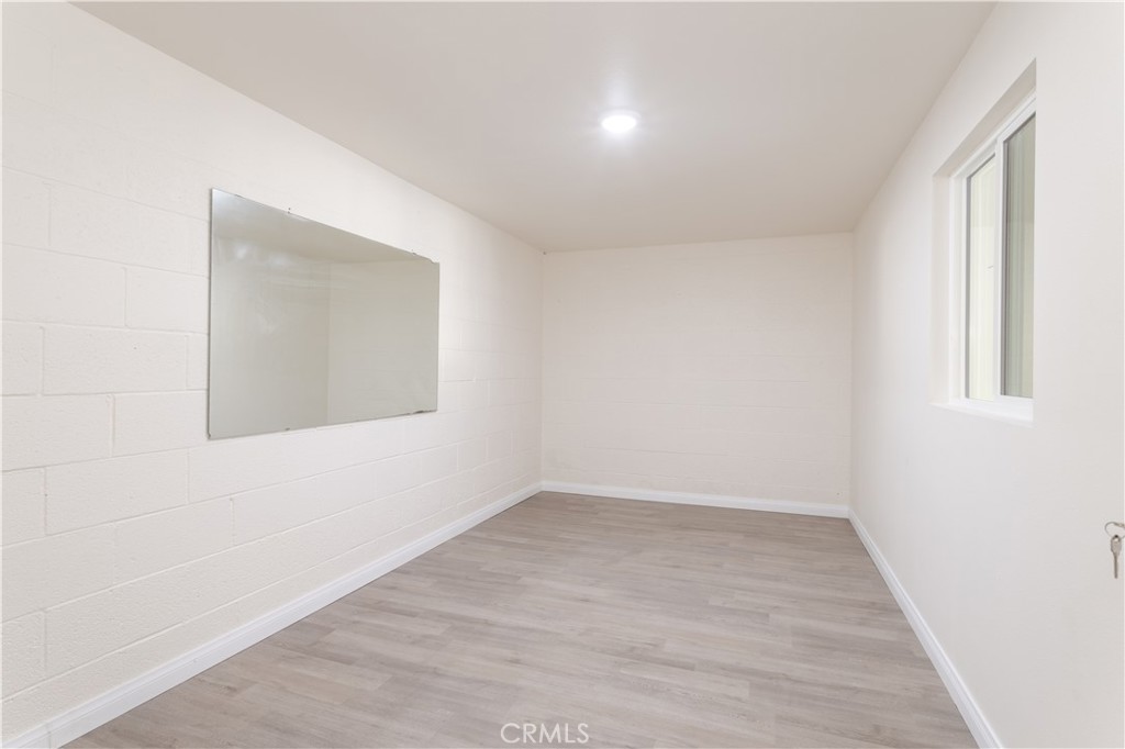 7809 Vía Udine Burbank, CA 91504 - Photo 17 of 34 an empty room with wooden floor and windows