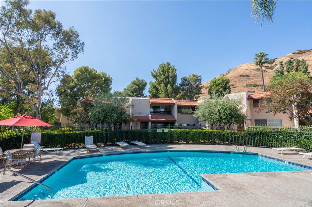7809 Vía Udine Burbank, CA 91504 - Photo 30 of 34 a front view of house with yard and swimming pool