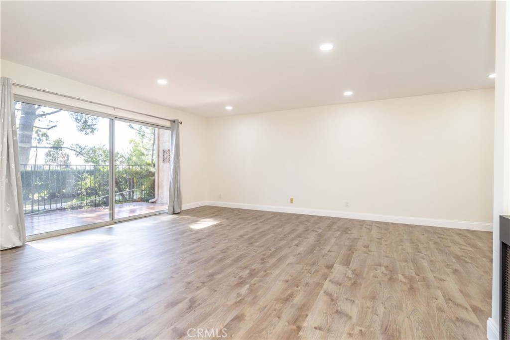 7809 Vía Udine Burbank, CA 91504 - Photo 4 of 34 an empty room with wooden floor and windows