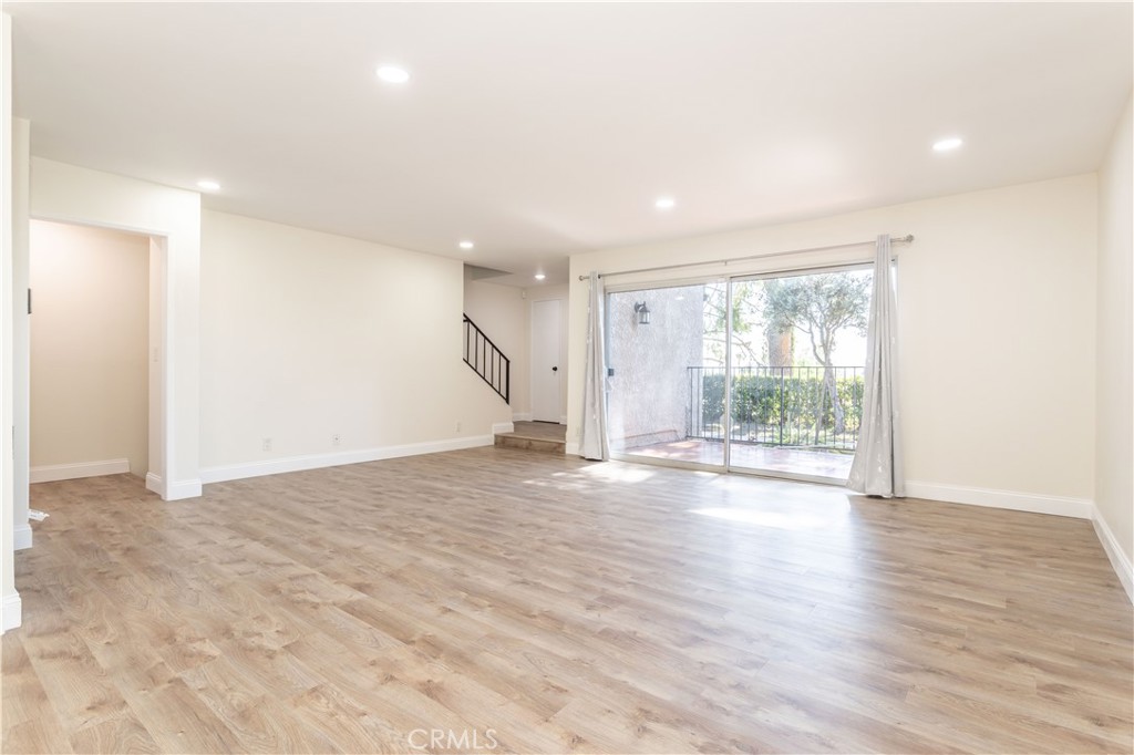 7809 Vía Udine Burbank, CA 91504 - Photo 5 of 34 an empty room with wooden floor and windows