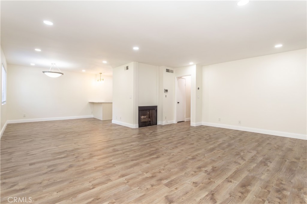 7809 Vía Udine Burbank, CA 91504 - Photo 6 of 34 a view of empty room with wooden floor and fireplace
