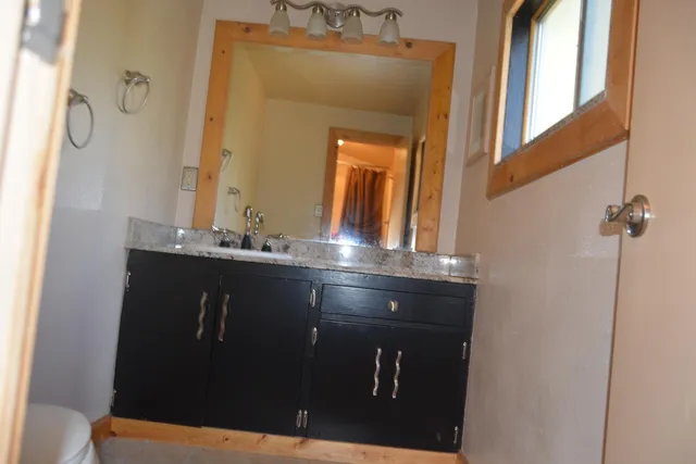 a bathroom with a sink vanity and a mirror