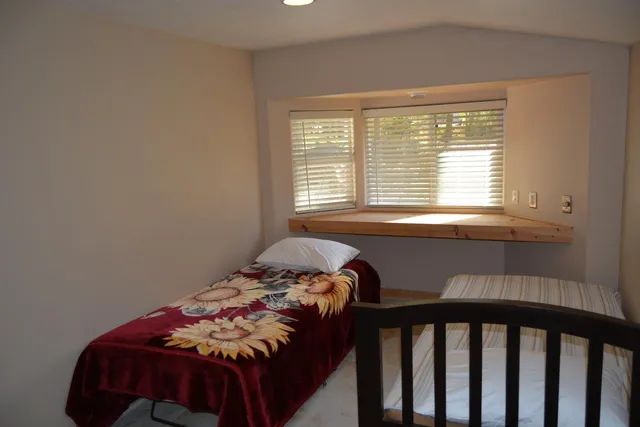 a bedroom with a bed and a window