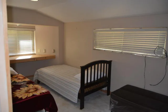 a bedroom with a bed and window