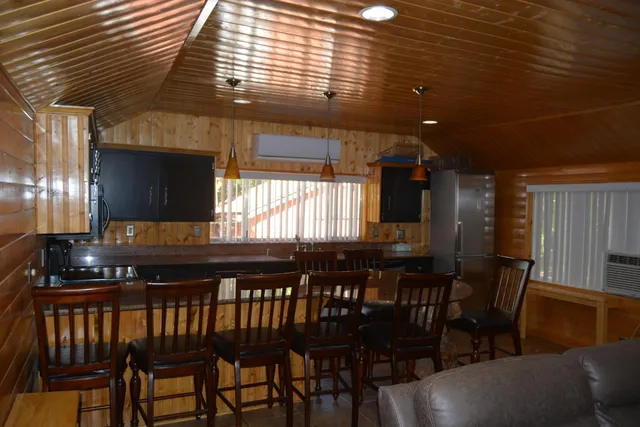 a kitchen with a dining table chairs and granite counter tops