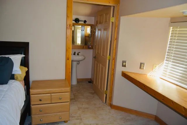 a bedroom with a bed and cabinet