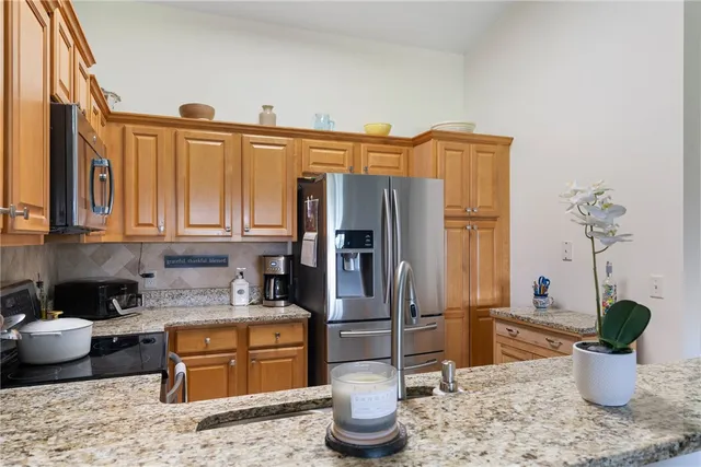 a kitchen with a refrigerator and a sink
