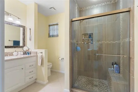 a bathroom with a shower a sink and mirror