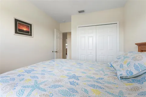 a bedroom with a bed and a painting on the wall