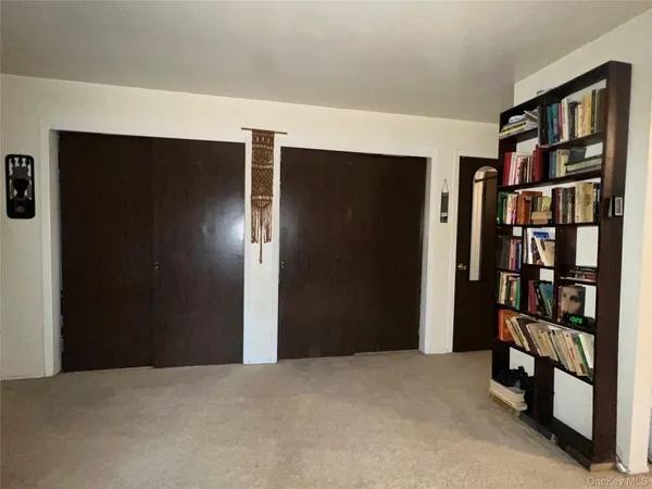 a view of an empty room with bookshelf