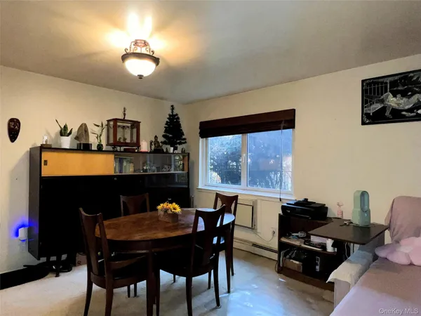 a view of a dining room with furniture and chandelier