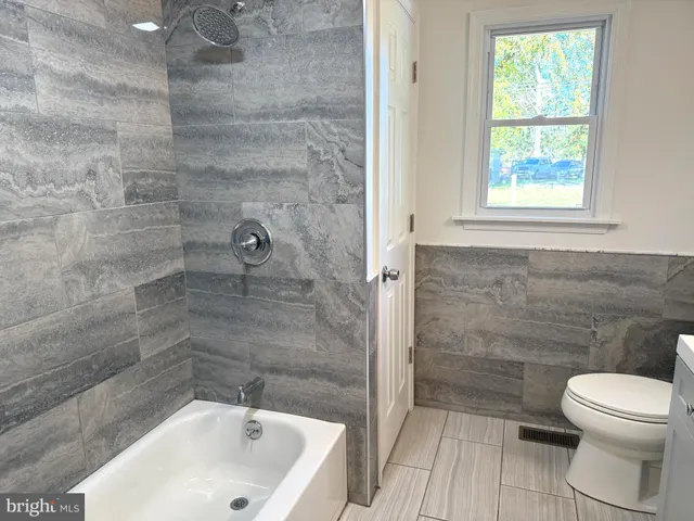 a bathroom with a bathtub and a toilet