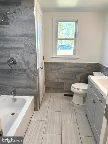 a bathroom with a sink a toilet and a bathtub