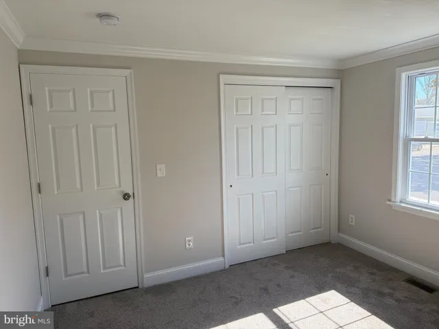 a view of an empty room with windows