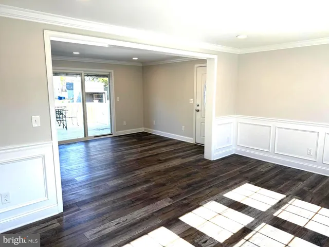 a view of wooden floor and windows in a room