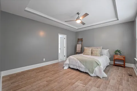 a bedroom with a bed and wooden floor